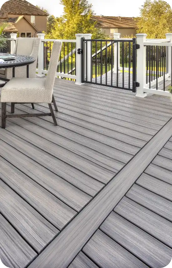 Photo of Trex deck with white railing and black gate.