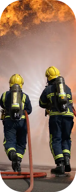 Firefighters / first responders spraying water on a fire.