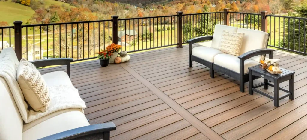 Photo from a modern-furnished Trex deck overlooking a beautiful vista of colorful trees in Fall across rolling hills.