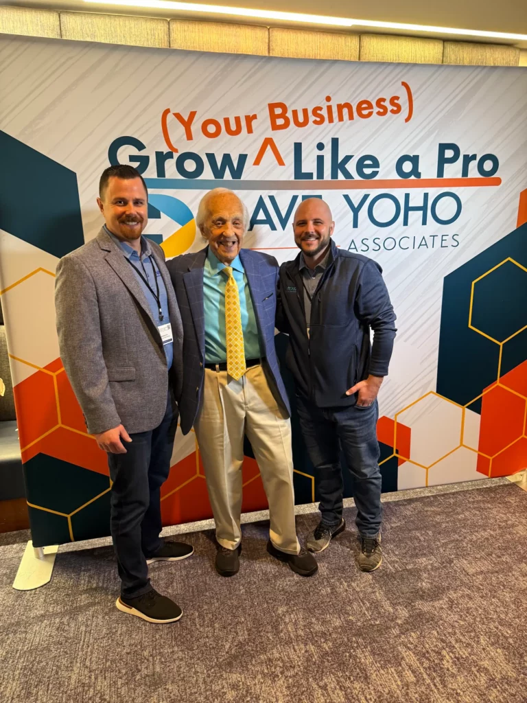 Convention photo of Dave Yoho of Grow Your Business Like a Pro standing between NexGen co-founders Andrew Levin and Jesse Bator.