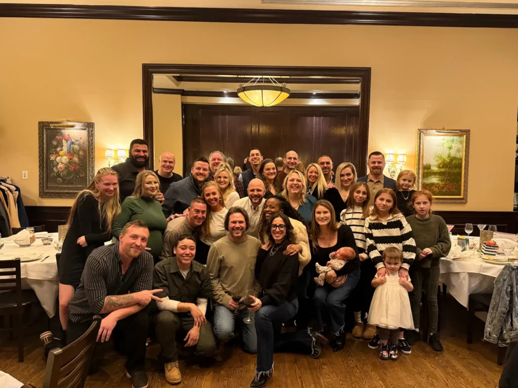 Group photo of NexGen Remodeling team members and family at their annual Holiday dinner party.