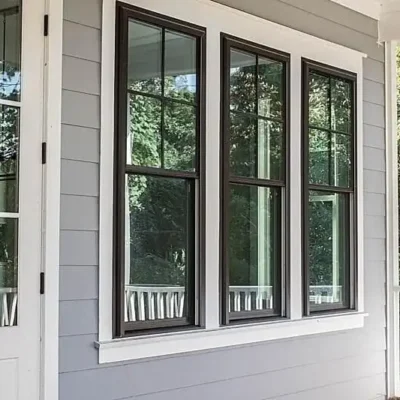 Photo of white trim around a dark brown casing enclosing three Viwinco windows.