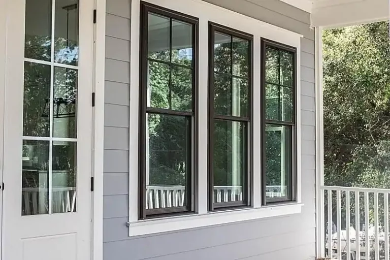 Photo of white trim around a dark brown casing enclosing three Viwinco windows.