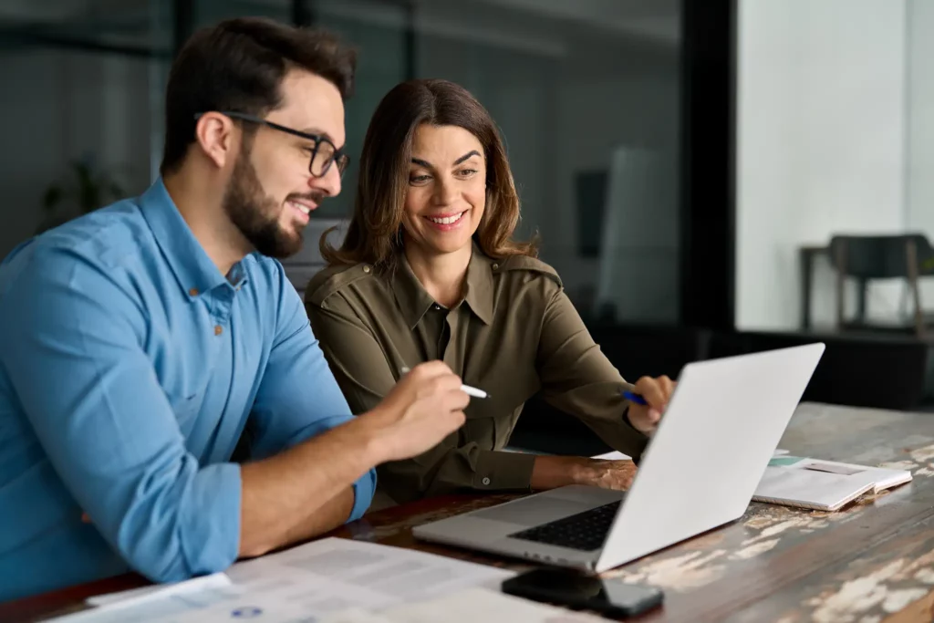 Photo of a couple going over finances on a laptop computer.