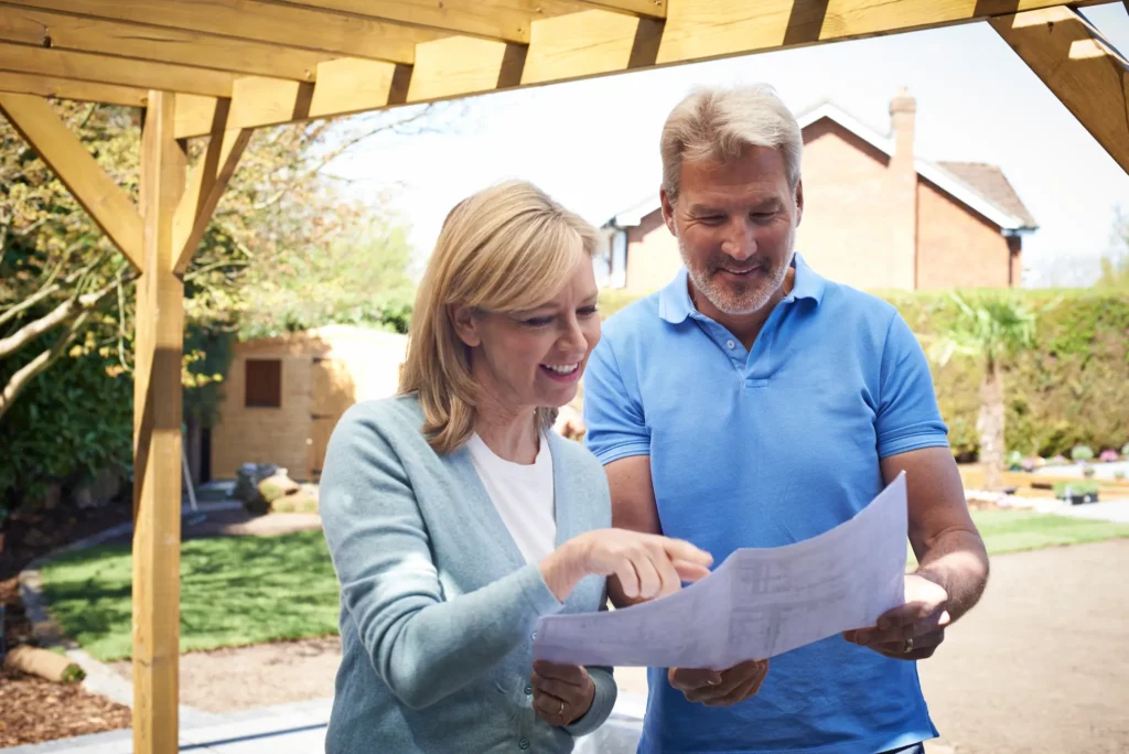 Photo of people reviewing a design plan / architectural drawing for home improvement.