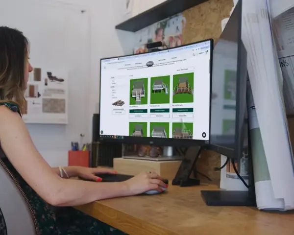 Photo of a person in front of a computer monitor viewing a website of various porch/deck design layouts available.