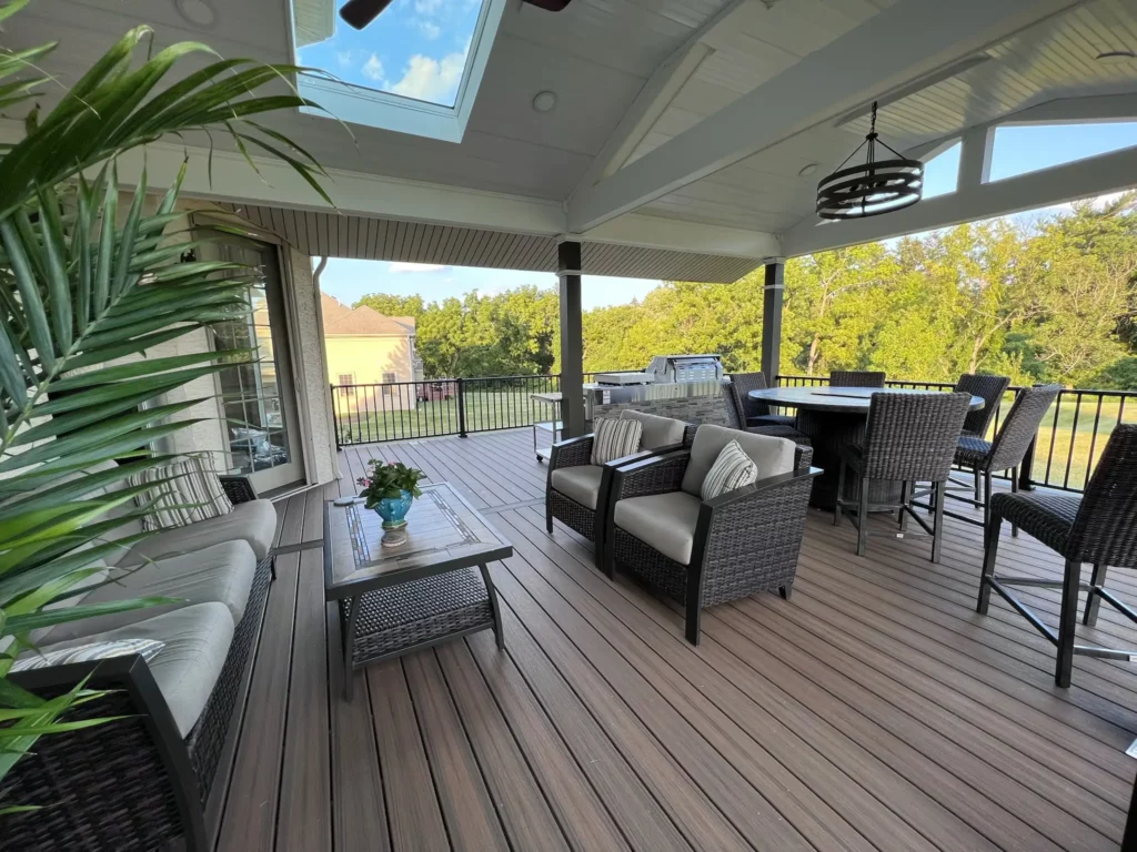 Photo of wicker-furnished, roofed Trex deck with sunroof and ceiling fan. Trex improves home value.
