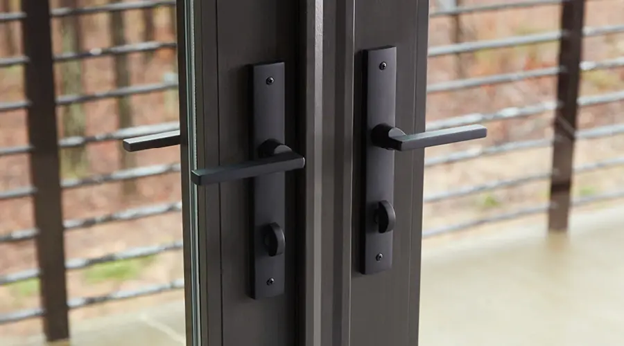 Close-up photo of the black lever handle and locking mechanism on glass doors that provide integrated security.