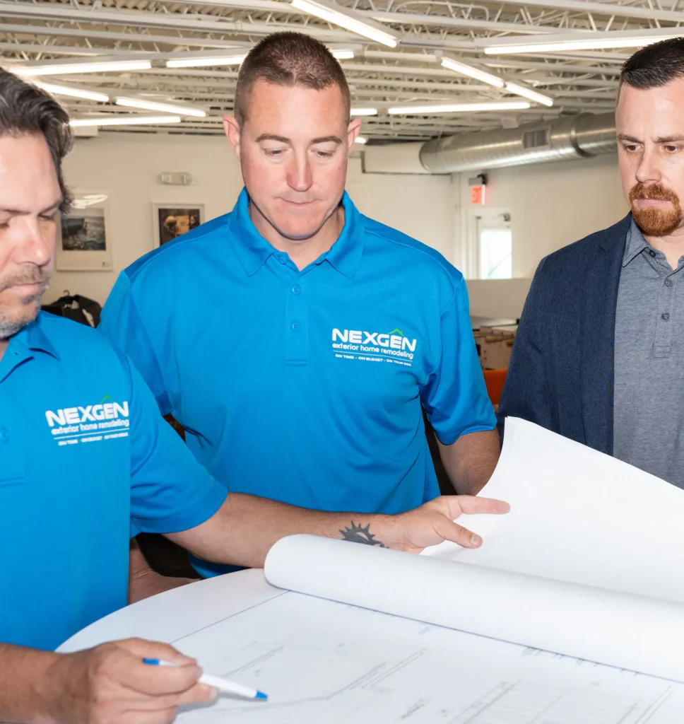 NexGen team members reviewing an architectural drawing.