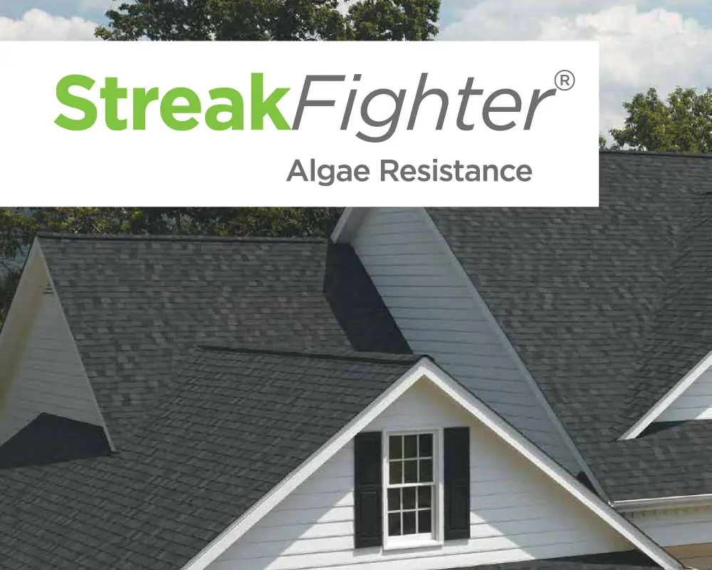 Photo of home with dark shingles and white siding with StreakFighter Algae Resistance.