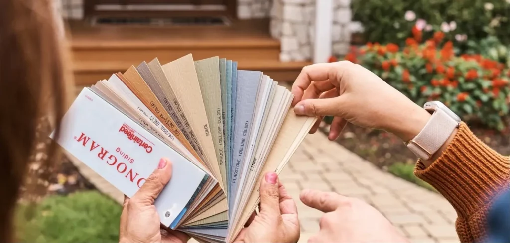 Photo of color swatches held up by two people deciding on their preferred color.